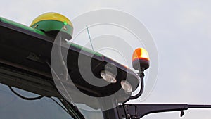Top part of combine tractor with orange rotating light