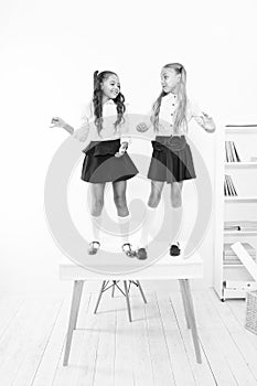 On the top. Popular girls in classroom. School friendship. Schoolgirls tidy appearance school uniform. Childhood