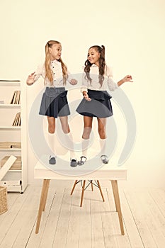 On the top. Popular girls in classroom. School friendship. Schoolgirls tidy appearance school uniform. Childhood