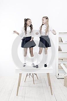 On the top. Popular girls in classroom. School friendship. Schoolgirls tidy appearance school uniform. Childhood