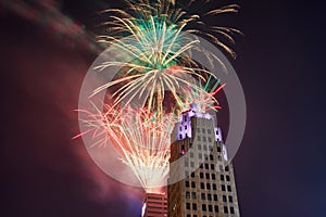 Top of purple Lincoln Tower with dazzling Fourth of July fireworks display in Fort Wayne