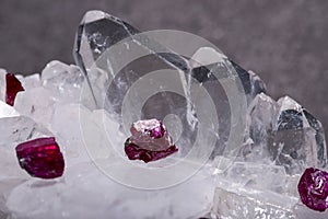 Top quality A grade small rough RUBY crystals from Tanzania on FADEN QUARTZ CLUSTER. Isolated on black