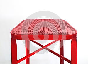 Top of red metal leg stool isolated on white background. Square high chair ideal for hotels, bars, kitchens, functional and modern