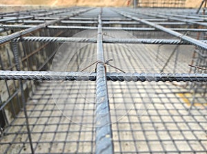 Top Reinforcement bar of footing. Two steel bar bounding with binding wier. photo