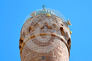The top, the roof of the minaret with the symbol of the crescent moon and the speakers through which the muezzin singer