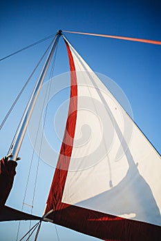 Top of the sailboat, mast head, sail and nautical rope yacht detail. Yachting, marine background