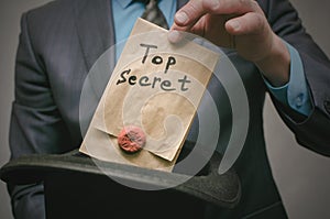 Top secret concept. Business man showing a Top secret documents or message in his hands.