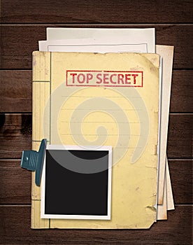 Top secret folder on wooden table.