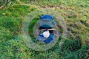 The top of a septic tank system sits in the grass