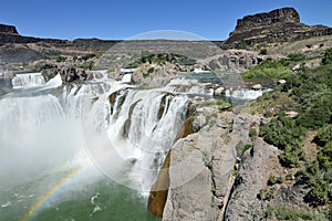 Top of shoshone falls mist with rainbow and rocks Twin Falls Idaho wide view horizontal