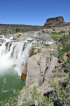Top of shoshone falls mist with rainbow and rocks Twin Falls Idaho wide view vertical