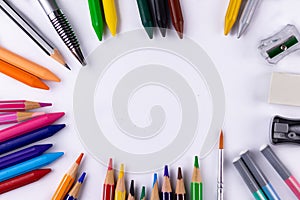 Top shot of crayon, pencil colors, paint brush, sharpeners, eraser -Classroom concept