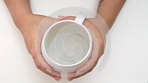 Top shot of female hand holding glass of water  on white