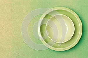 top shot green bowl and plate on yellow - green background