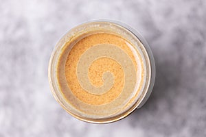 Top shot of a peanut butter in a glass cup