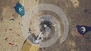 The top shot of a tourist lying in a ward. Beer bottles are scattered everywhere