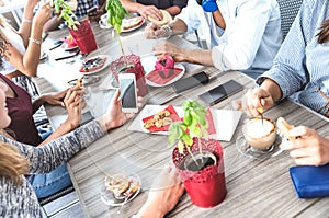 Top side view of friends drinking cappuccino at coffee shop restaurant - People having fun together eating and using mobile phone