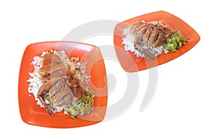 Stewed pork leg on rice in an orange plastic dish, paired with pickled lettuce.isolated on white background with clipping path.