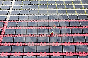 Top and side view and wide shot of two technician workers check and maintenance solar cell panel over the water reservoir as solar