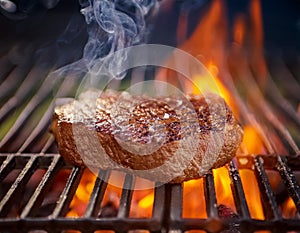 A top sirloin steak flame broiled on a barbecue, shallow depth of field. photo