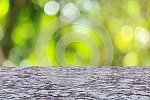 Top stone table with sunny abstract green nature background, blu