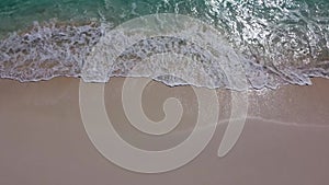 Top straight down aerial view above sandy beach