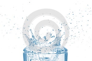 Top of transparent glass and blue water splash isolated on white background.