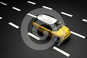 Top upper view of a Yellow Mini Cooper S Toy car on yellow background