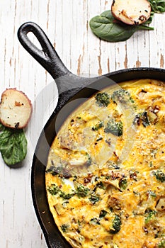 Top vertical view of baked egg fritatta with spinach