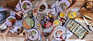 Top vertical view of table full of food and drinks and happy people friends celebrating and. enjoy together eating and having fun