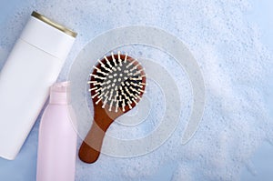 Top vie of wooden brush, shampoo ad