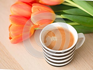 From top vies blackcoffee with orange tulips concetp for morning coffee from top views