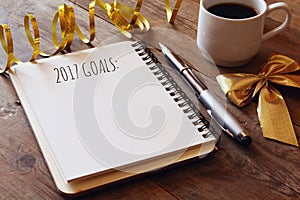 Top view 2017 goals list with notebook, cup of coffee