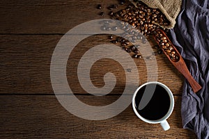 Top view above of Black hot fresh coffee in white ceramic cup with coffee beans roasted