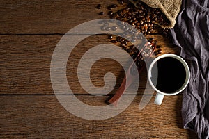 Top view above of Black hot fresh coffee in white ceramic cup with coffee beans roasted