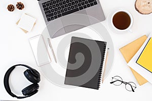 Top view above of white office desk table with keyboard computer, notebook and coffee cup with equipment other office