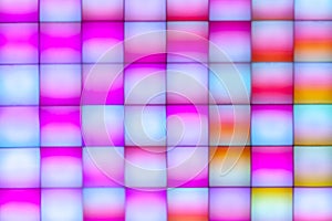 Top view abstract colorful disco led panel. modern light equipment for design or ornament.pink and yellow color gradient squares.