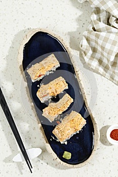Top View Aburi Sake Mentai Roll with Cheese in Blue Oval Long Plate
