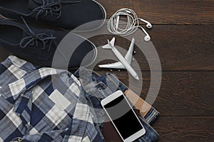 Top view of accessories clothing gentlemen to travel with technology background concept