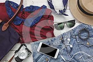 Top view of accessories clothing women to travel with technology background concept.