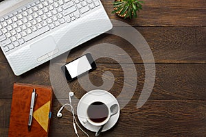 Top view accessories office desk the mobile phone,note paper,pencil,coffee,cactus on wooden office desk background.