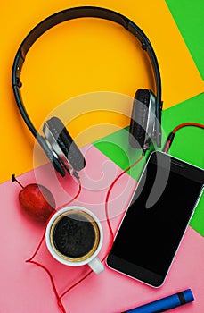 Top view accessories office desk.smartphones headphones on colorful background