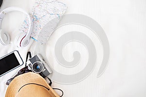 Top view of accessories travel camera,hat,headphone,map on be