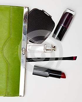 Top view accessories for woman. Stylish sunglasses, green bag , lipstick , perfume , fashion flat lay on white