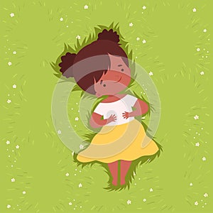 Top View of Adorable African American Girl Lying Down on Green Lawn, Cute Kid Lying on Grass Dreamily Looking into Sky