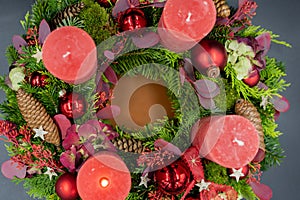 Top view of advent wreath with one red burning candle on gray background