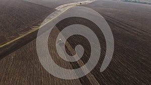 Top view or aerial dron view on tractor plows the agricultural field. Agricultural concept. 4k resolution.