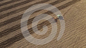 Top view or aerial dron view on tractor plows the agricultural field. Agricultural concept. 4k resolution.