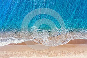Top view aerial drone photo of Perissa beach with beautiful turquoise water and sea waves. Vacation travel background. Aegean sea