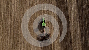 Top view or aerial drone view on tractor plows the agricultural field. Agricultural concept. Full HD resolution drone